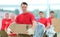 Foreman and workers with boxes of building materials