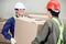 Foremen Carrying Cardboard Box At Warehouse