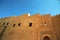 Foreshortening of the external walls of the fort under an intense blue sky, Oman