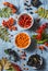 Forest autumn berries - sea buckthorn, ashbery, viburnum, rose hips on a gray background, top view. Super food ingredients