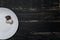 Forest champignon and trichomola mushrooms on white plate standing on black boards of table.