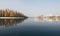 Forest and city skyline reflecting in water