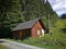 Forest cottage in summer, standing on the edge of the forest, near the slope with ski lift