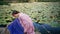 Forest fairy sitting lake covered water lilies close up. Dreamy woman posing