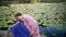 Forest fairy sitting lake covered water lilies close up. Dreamy woman posing