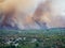 Forest fire in Croatia, summer natural disaster close to national park Krka, Sibenik region, boats and yachts escaping Skradin to