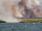 Forest fire in Croatia, summer natural disaster close to national park Krka, Sibenik region, boats and yachts escaping Skradin to