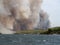 Forest fire in Croatia, summer natural disaster close to national park Krka, Sibenik region, boats and yachts escaping Skradin to