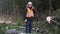 Forest inspector talking on smartphone in destroyed forest at spruce