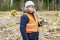 Forest inspector using tablet PC in clearcutting forest