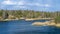 Forest lake in early spring with blue water and cloudy picturesque sky. Background