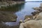 Forest lake shore in Tennessee, layered stones on the shore