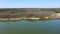 Forest on the lake. Trees are reflected in the water. Aerial view.