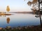 In the forest, the leaves on the trees turned yellow on the shore of small a natural reservoir