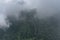Forest and mountains in fog in cloudy weather. Beautiful landscape of National Park of Russia top view from drone. Dark