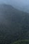 Forest and mountains in fog in cloudy weather. Beautiful landscape of National Park of Russia top view from drone. Dark