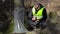 Forest Officer using tablet PC near tree with birch juice