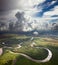 Forest river under the white clouds