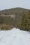 Forest road in the winter Carpathian Mountains. The path to the highest mountain of Ukraine-Hoverla