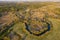 Forest in spring colors. Green deciduous trees and meandering blue river in sunset.