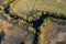 Forest in spring colors. Green deciduous trees and meandering blue river in sunset.