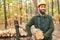 Forest worker or lumberjack at the wood harvest