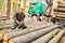 Forest workers loading long logs