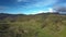 Forested and bare hills in highland upper view