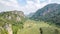 Forested mountain meadow slope landscape view in low lying cloud