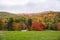 Forested mountain shrouded in low clouds in autumn. Stunning autumn colours.