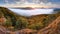 Forested mountain slope in mist in a scenic landscape.