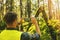 Forestry inspector at a forest inspection. taking picture of a fallen tree with phone