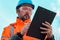 Forestry technician collecting data and writing at clipboard notepad