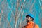 Forestry technician looking up at treetops