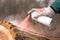 Forestry technician marking tree trunk with red aerosol can paint