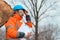 Forestry technician posing with clipboard notepad next to tree log