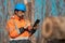 Forestry technician using digital tablet computer in forest