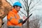 Forestry technician writing notes on clipboard notepad paper in forest