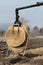 Forestry tractor crane arm with grapple lifting a bundle of straw