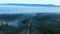 Forests and mountains of the Southern Urals near the village of Tyulyuk in Russia early in the morning. Drone view.