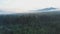 Forests and mountains of the Southern Urals near the village of Tyulyuk in Russia early in the morning. Drone view.