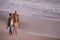 Forever is not enough with you. Shot of a young couple enjoying a romantic stroll on the beach.