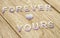 Forever yours on wooden background wallpaper