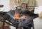 Forge horn with burning coals in a homemade bowl preparation