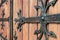 Forged door pattern, decorative. Old vintage entrance, massive heavy wooden door of church or cathedral