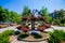 Forged metal architectural form with petunias pots