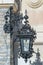 Forged openwork lantern on the wall of Peles castle in Romania