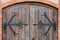 Forged pattern on door with decorative elements, Old vintage entrance, massive heavy wooden door of church or cathedral