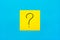 Forget, reminder, combination of colour concept- Close up black handwritten symbol of question mark on one yellow square sticker