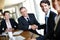 Forging business relationships. A group of professional businesspeople in a meeting and concluding a deal with a